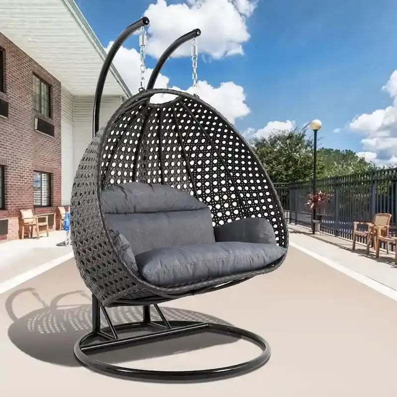 LeisureMod 2-Person Hanging Egg Chair – Indoor/Outdoor Rattan Wicker Swing with Stand and Cushioned Lounger