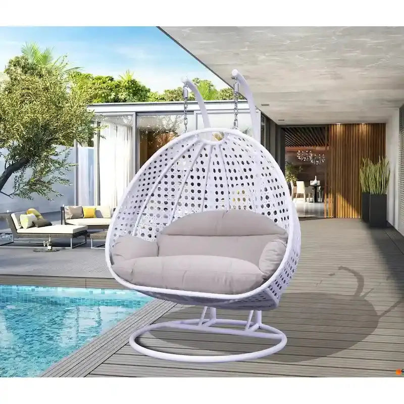 LeisureMod 2-Person Hanging Egg Chair – Indoor/Outdoor Rattan Wicker Swing with Stand and Cushioned Lounger